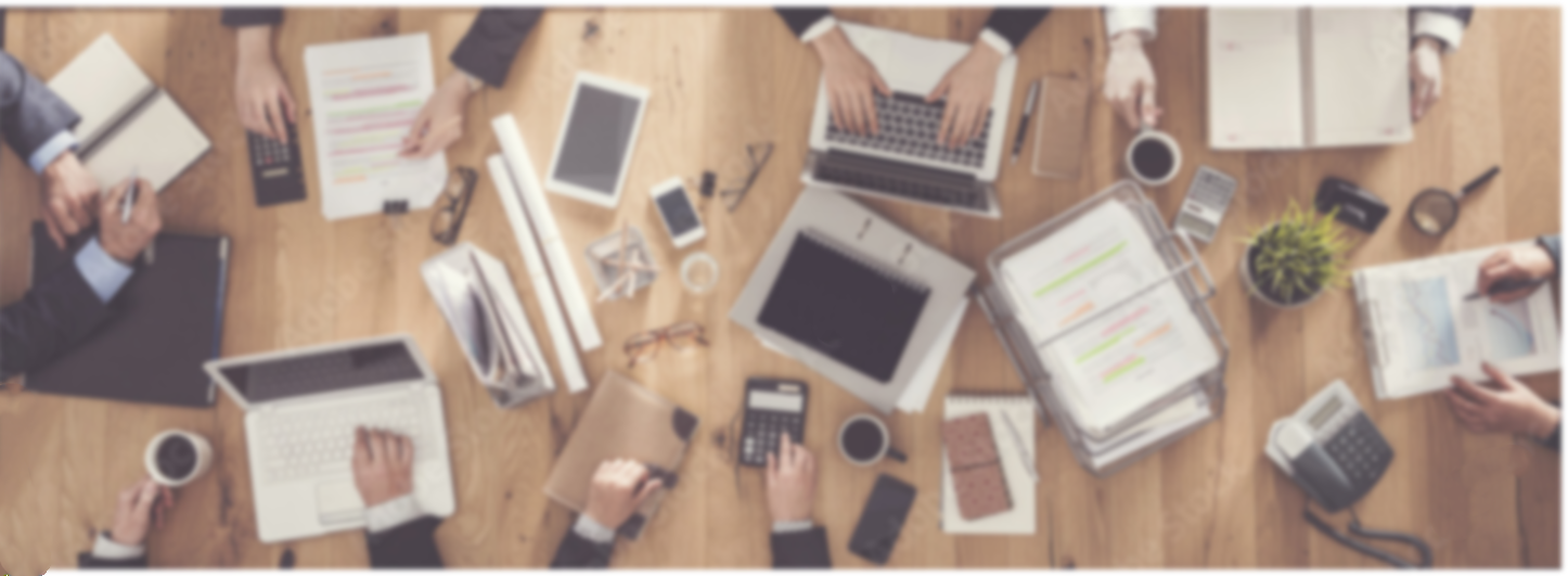 overhead image of colleagues and laptops